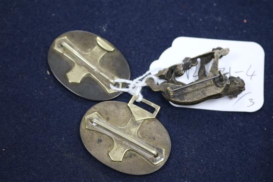 A Japanese shakudo work belt buckle and a bronze big cat brooch